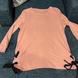 Light pink sweater with black rope ties on each side